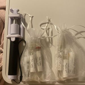 Selfie Stick. 2 lip balms. 4 orange mask sprays/air mister. In mesh bags